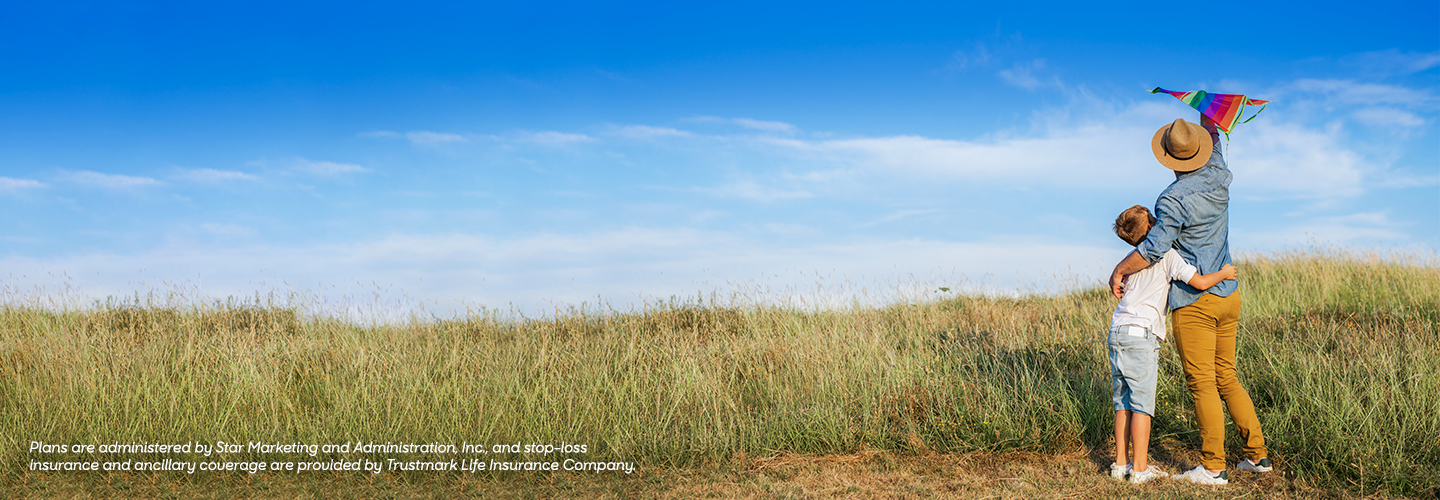 Member with dependent at beach with kite. Small Business Benefits member login